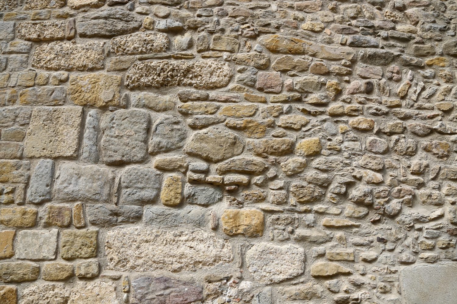 Very ancient stone wall, architectural background, closeup texture